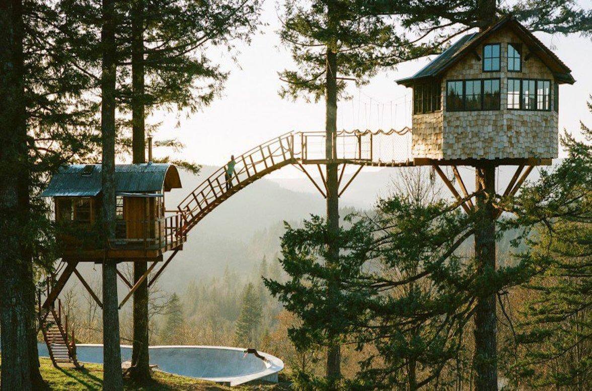 image of a complex treehouse with a bridge